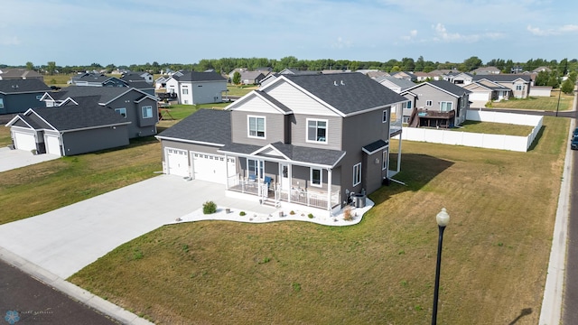 view of front of house with a garage, a front lawn, covered porch, and central air condition unit