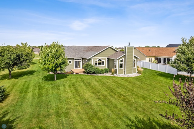 back of house featuring a lawn