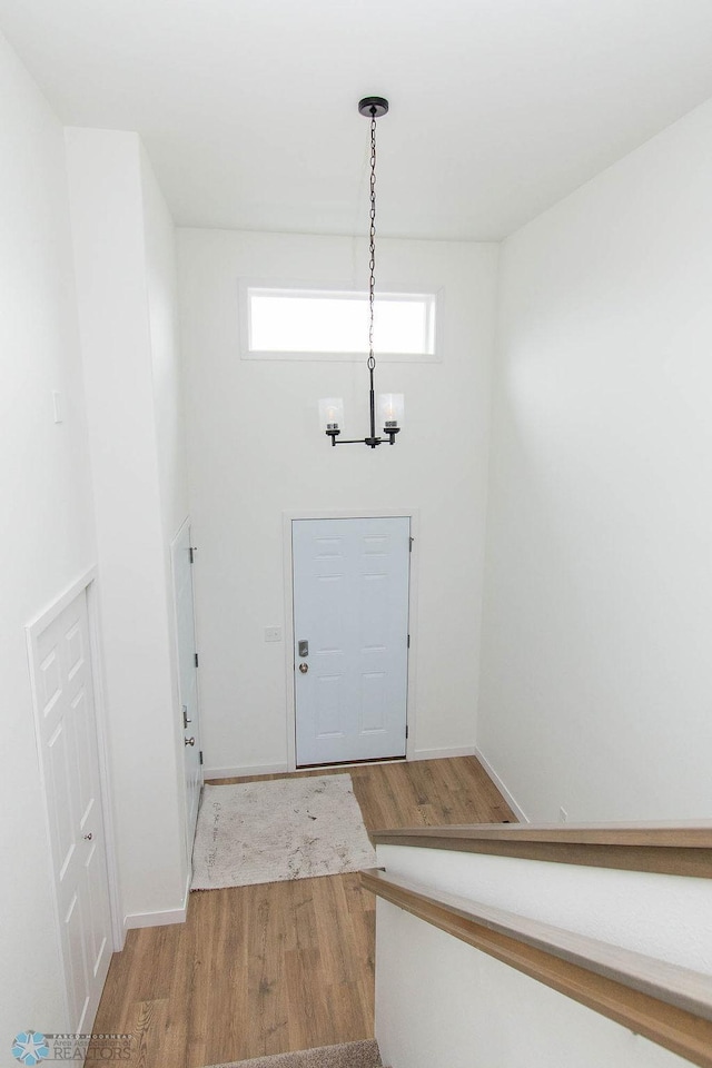 entrance foyer with an inviting chandelier and light hardwood / wood-style floors