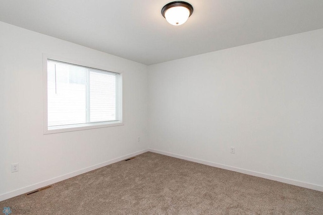 unfurnished room featuring light colored carpet