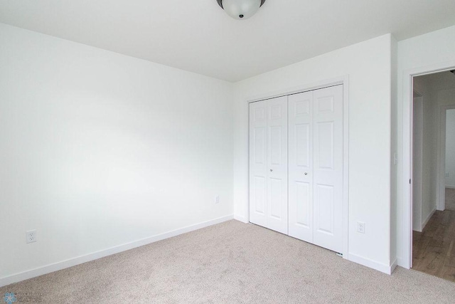 unfurnished bedroom with a closet and carpet floors