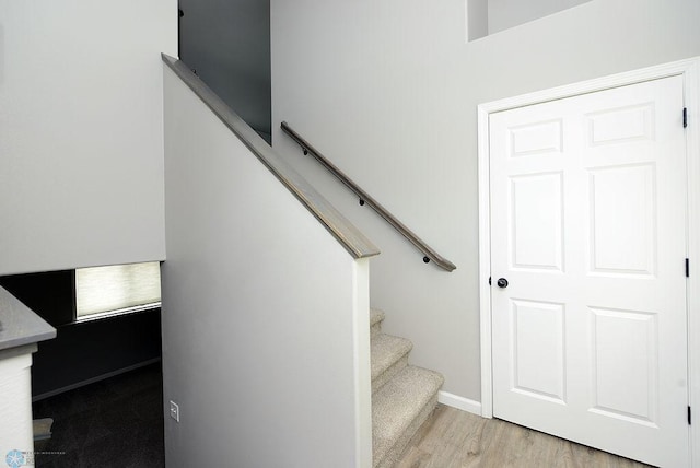 staircase with wood-type flooring