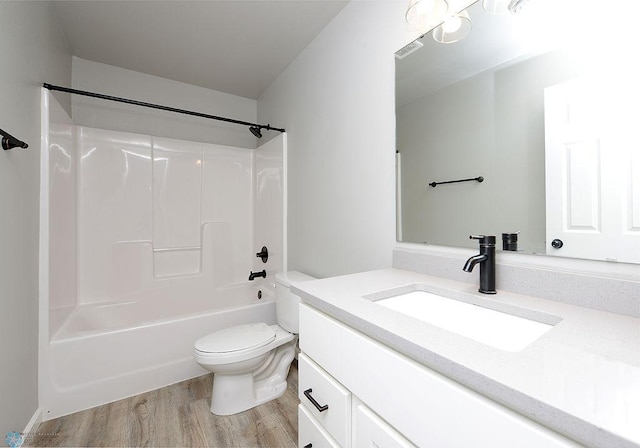 full bathroom featuring wood-type flooring, toilet, shower / bath combination, and vanity