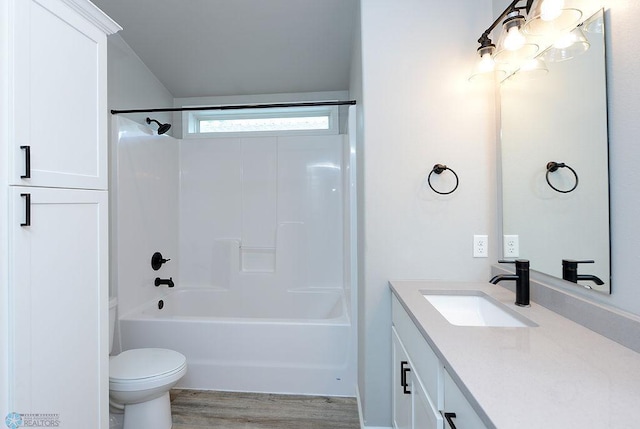 full bathroom with vanity, toilet, wood-type flooring, and shower / tub combination