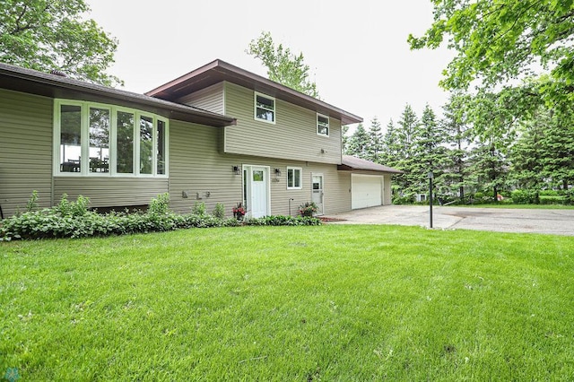 split level home featuring a garage and a front lawn