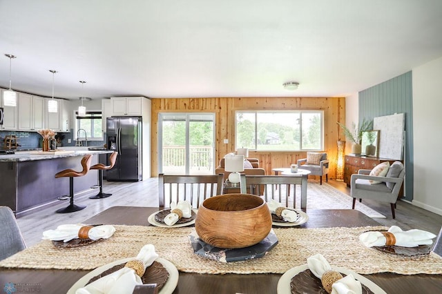 living room featuring wooden walls and light hardwood / wood-style floors