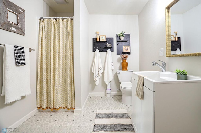 bathroom featuring vanity, toilet, and a shower with shower curtain