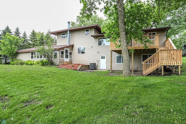 rear view of house with a wooden deck, a lawn, and central AC