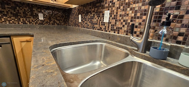 details featuring dishwasher, sink, and decorative backsplash