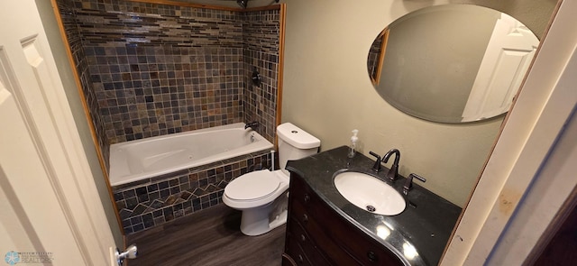 full bathroom featuring wood-type flooring, vanity, toilet, and tiled shower / bath