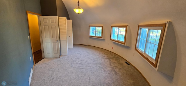 unfurnished bedroom with lofted ceiling and light colored carpet