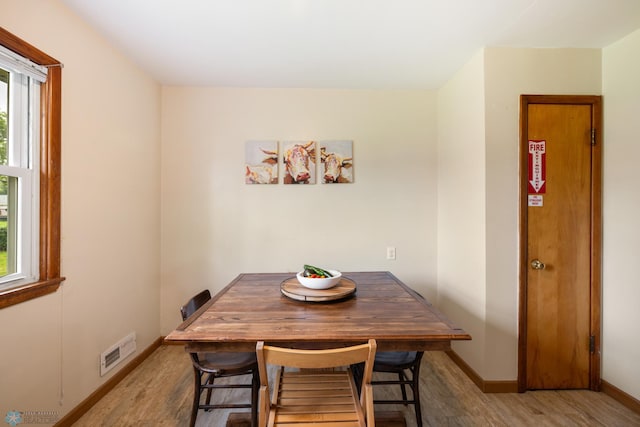 dining space with light wood-type flooring