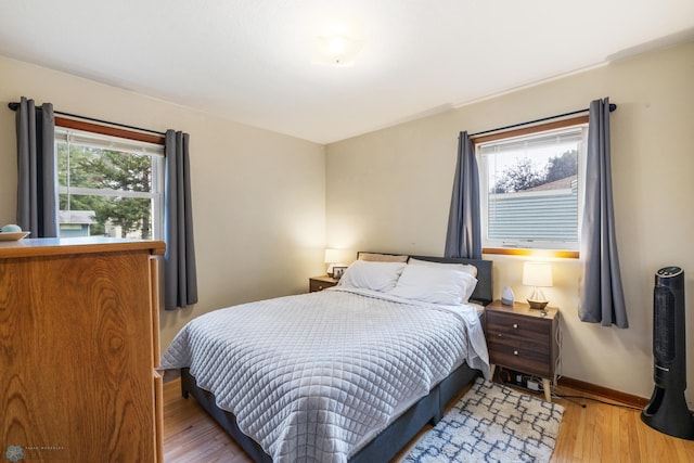 bedroom featuring multiple windows and hardwood / wood-style floors