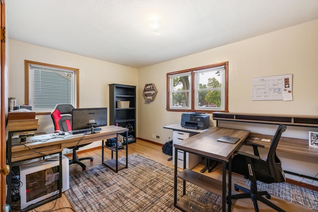 home office with wood-type flooring