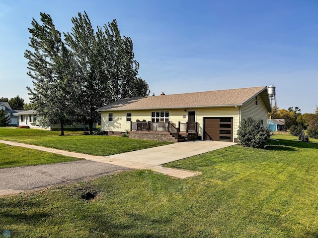 ranch-style house featuring a front lawn, a deck, and a garage