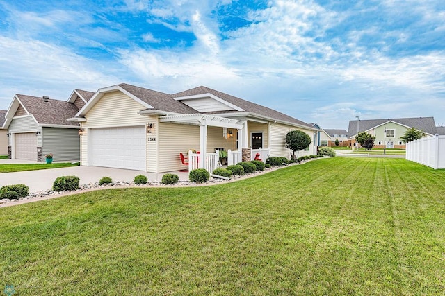 view of front of house with covered porch, a front yard, and a garage