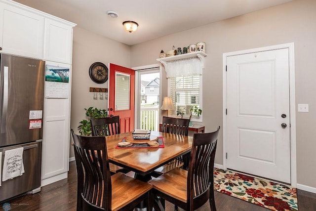 dining space with dark wood-type flooring