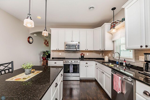 kitchen featuring white cabinets, appliances with stainless steel finishes, sink, and dark wood-type flooring