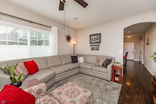 living room featuring dark hardwood / wood-style flooring and ceiling fan