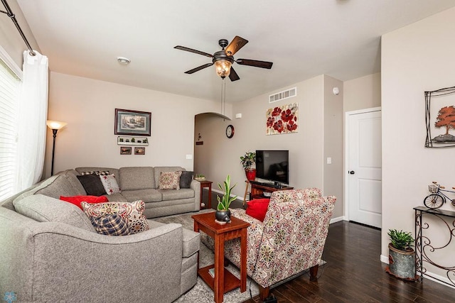 living room with dark wood-type flooring and ceiling fan