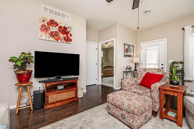 interior space with dark wood-type flooring and ceiling fan