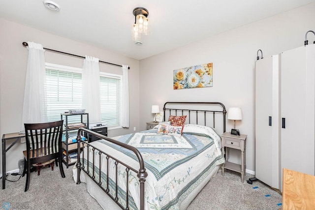 bedroom featuring light carpet