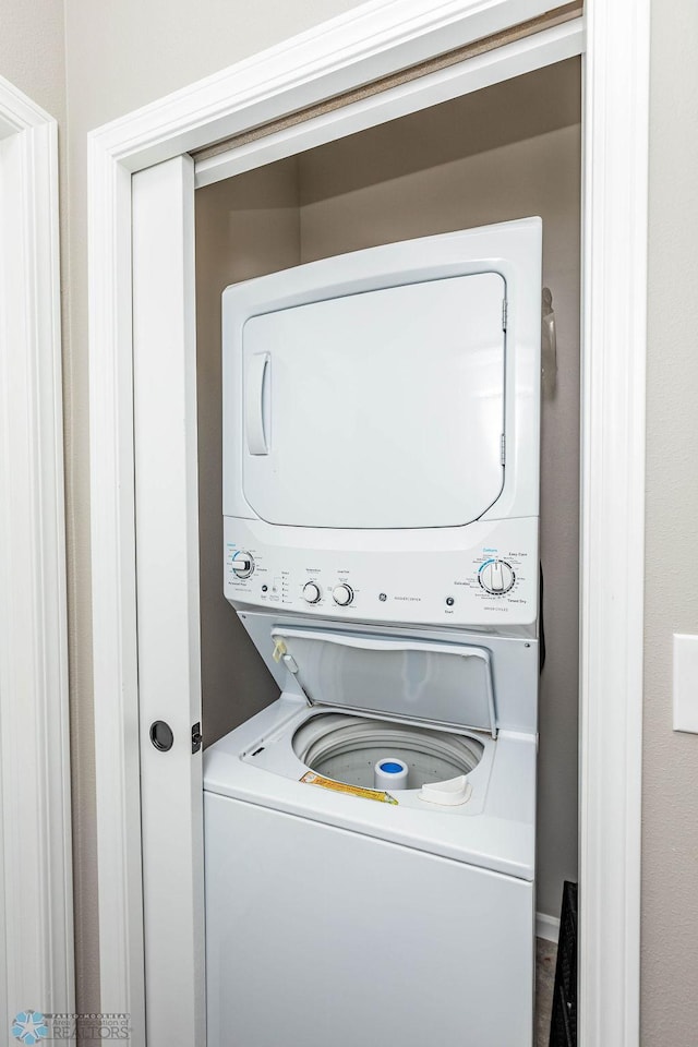 laundry room with stacked washer / dryer