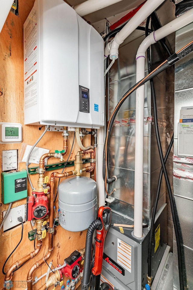 utility room featuring tankless water heater