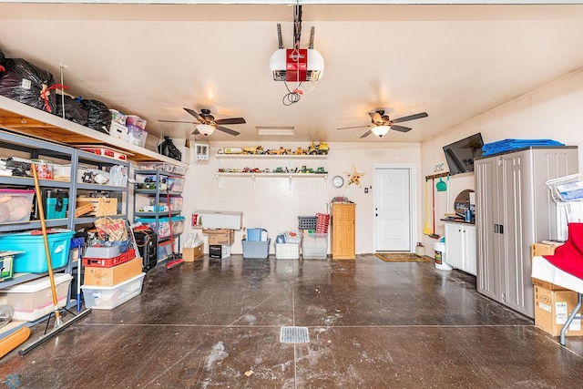 garage with ceiling fan and a garage door opener