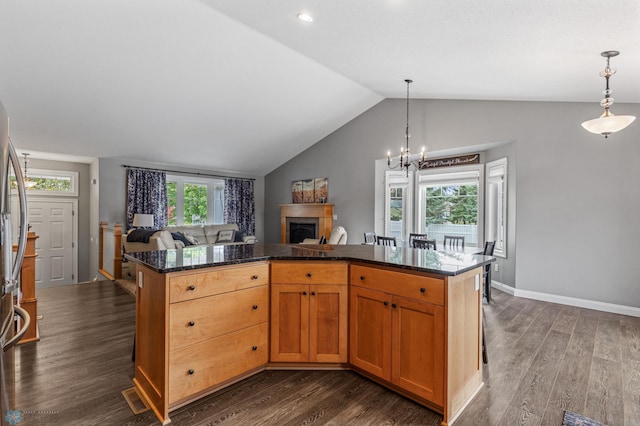 kitchen with a healthy amount of sunlight, dark hardwood / wood-style floors, and vaulted ceiling