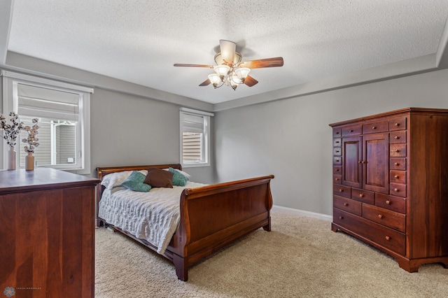 carpeted bedroom with a textured ceiling and ceiling fan