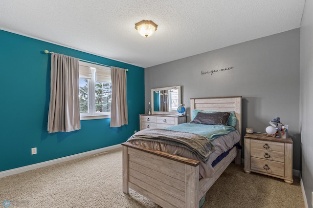 bedroom with a textured ceiling and carpet floors