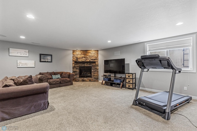 living room with a fireplace and carpet