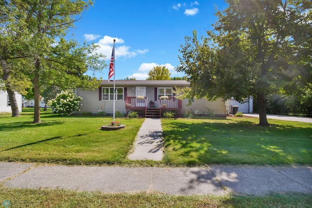 ranch-style home with a garage, a front yard, and a porch