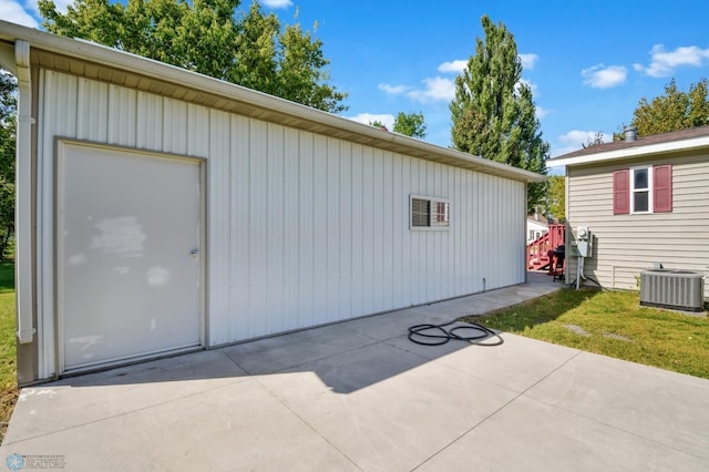 garage featuring central AC and a yard