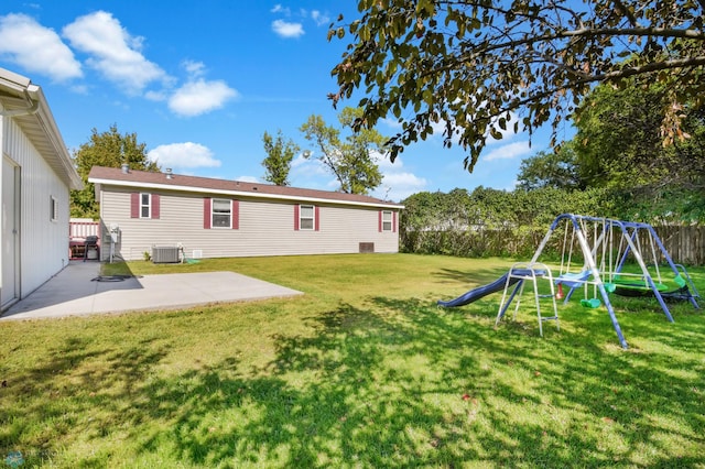 view of yard featuring a playground, a patio area, and central AC