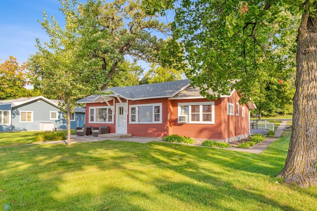 view of front of house with a front yard and a patio