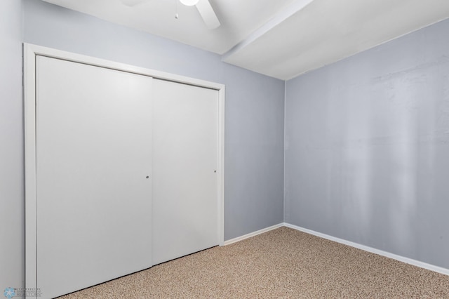 unfurnished bedroom featuring carpet, ceiling fan, and a closet