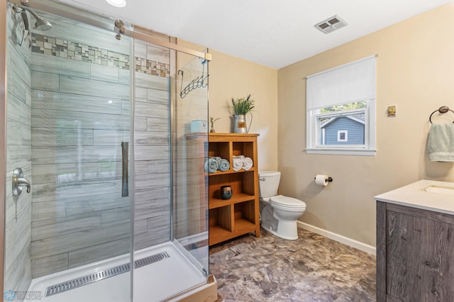 bathroom featuring a shower with door, vanity, and toilet