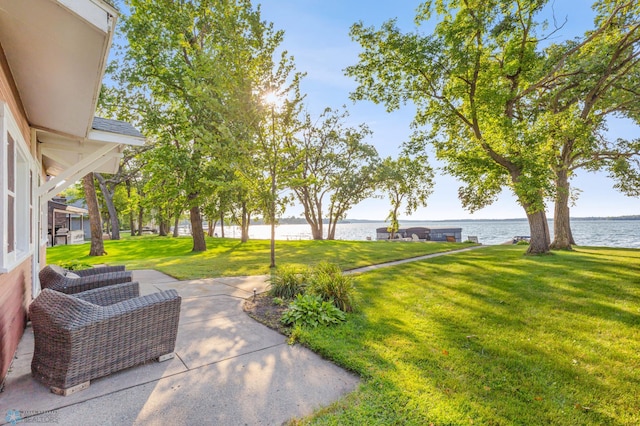 view of yard featuring a water view and a patio area