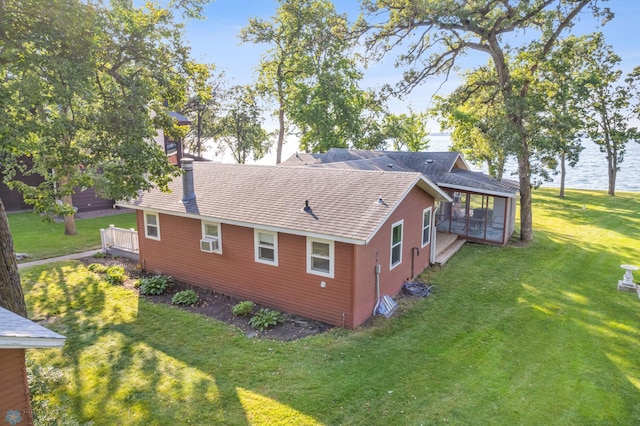 view of home's exterior featuring a water view and a lawn