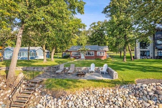 back of property with a yard and a patio