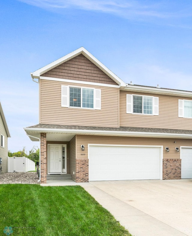 view of front facade featuring a garage and a front yard