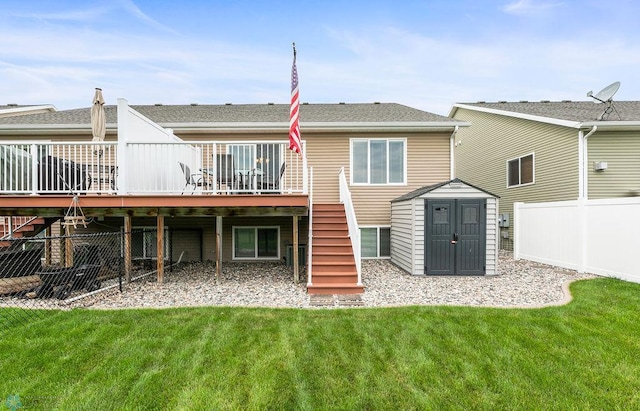 back of property featuring a lawn, a storage unit, and a deck