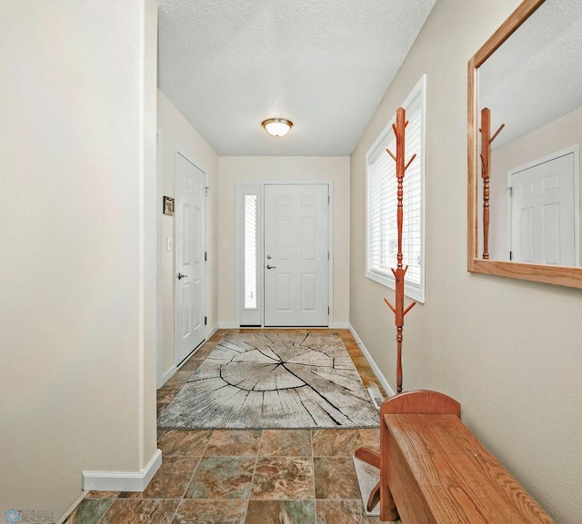 foyer featuring a textured ceiling