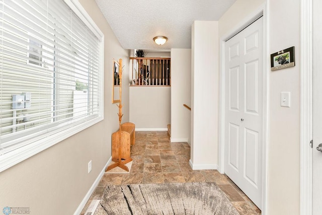 corridor featuring a textured ceiling