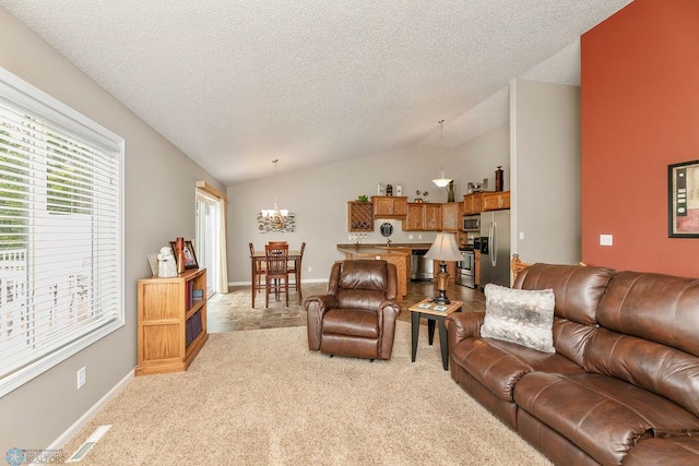 carpeted living room with lofted ceiling, an inviting chandelier, and a textured ceiling