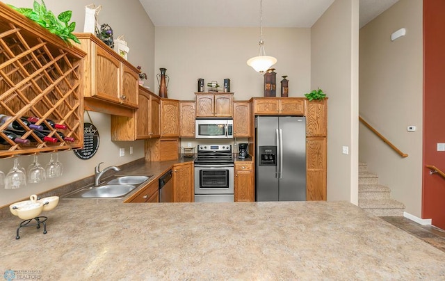 kitchen with kitchen peninsula, sink, and appliances with stainless steel finishes