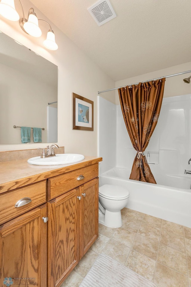 full bathroom with a textured ceiling, vanity, toilet, and shower / bath combination with curtain