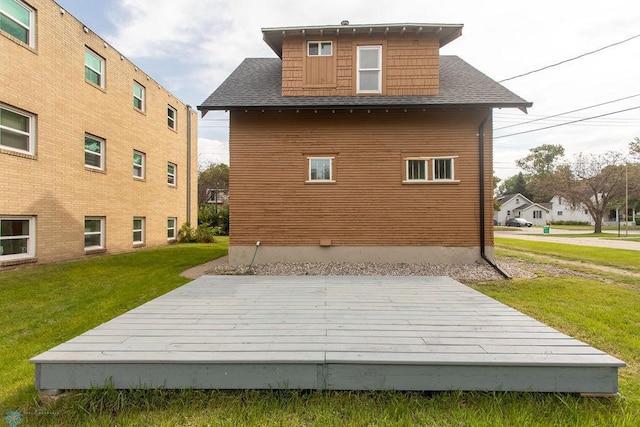 back of house with a lawn and a wooden deck